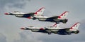 Fighter jets soaring in formation through a cloudy sky: U.S. Air Force Thunderbirds Royalty Free Stock Photo