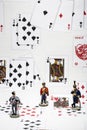 Three figures of a hussar in the background of playing cards