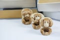 Three figurines of monkey with many books Royalty Free Stock Photo