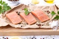 Three fillets of fresh raw salmon fish with spices and herbs on cutting board Royalty Free Stock Photo