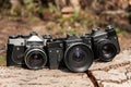 Three film old professional cameras with lenses