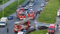 Three fire engines caused a traffic jam on the road. A hose with water will be stretched across the roadway to extinguish the fire