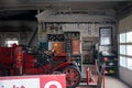 fire engines sit inside of a garage full of tools and materials