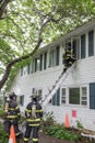 Three Firefighters on Fire Scene in front of a building