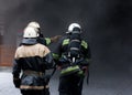 Three Firefighters, going in a fire.