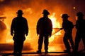 Three firemen in uniform fighting a fire Royalty Free Stock Photo