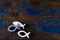 Three fish shapes on an old wooden surface Royalty Free Stock Photo