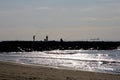 Three fishermen silhouettes in the sunset, over the rocks Royalty Free Stock Photo