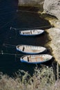 Three fishing boats aerial view are tied to the shore near the fishing enterprise. mooring with boats Royalty Free Stock Photo
