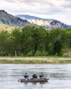 Three Fishing the Missouri Sitting with Backs to Camera Royalty Free Stock Photo