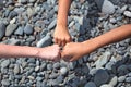 Three fist hands children centre on the beach.