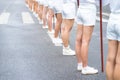 Three fit beautiful young women athletes in lingerie and boots standing grouped together showing their toned buttocks and leg