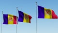 Three flags of Andorra waving in the wind against blue sky.