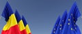 Three flags of European Union and Romania on flagpoles on the sides. Flags on a blue background. Place for text. EU, Europe.