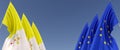 Three flags of European Union and the Vatican on flagpoles on the sides. Flags on a blue background. Place for text. EU, Europe.