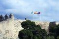 Three flags: Spain, Andolusia and Malaga on the defensive wall of the fortress. Arab fortress Gibralfaro Spanish. Castillo de Jib