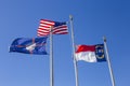 Three flags waving backwards in the outdoors on a cold sunny day Royalty Free Stock Photo