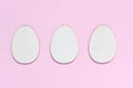 Three flat wooden blanks for creativity in shape of egg on pastel pink background. Happy Easter concept. Mockup for greeting card