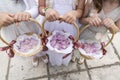 Three flower girls holding baskets with rose petals