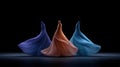 Three flowing dresses in vibrant colors dancing against a dark backdrop Royalty Free Stock Photo