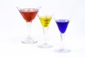 Three colorful drinks isolated against a white background