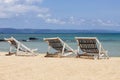 Three folding beach chairs on the beach with sea and bright sky in the background at Koh Mak in Trat, Thailand. Seasonal Vacation