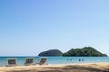 Three folding beach chairs on the beach with sea and bright sky in the background at Koh Mak in Trat, Thailand. Seasonal Vacation