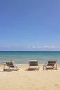 Three folding chairs on the beach with sea and bright sky in the background at Koh Mak in Trat, Thailand. Seasonal Vacation.