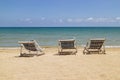 Three folding chairs on the beach with sea and bright sky in the background at Koh Mak in Trat, Thailand. Seasonal Vacation.