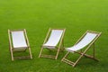 Three folding chairs in a green park