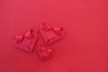 three folding red paper hearts on red for pattern and background