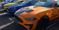 Three Ford Mustang Cars parked in a row Orange Yellow and Blue Royalty Free Stock Photo