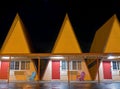 Three of the A-frame rooms of the Ranch Motel at night in Oakland, Oregon, USA - November 11, 2022