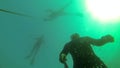 Three freedivers on the lake in slow motion