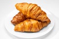 Three French croissants on white plate on white background. Royalty Free Stock Photo