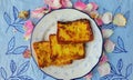 Frech toasts in a blue leave patterned plate with blue outline.