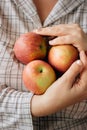 Three fresh apples in a woman hands. Royalty Free Stock Photo