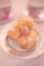 Three fresh croissants in silver plate on the white table Royalty Free Stock Photo