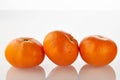 Three fresh juicy mandarins fruits isolated on the white background Royalty Free Stock Photo