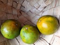 three fresh limes in an old traditional basket