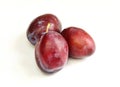 Three fresh plums isolated on white background. Tasty organic fruit Royalty Free Stock Photo