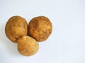 Three fresh potatoes, unpeeled, isolated on white background Royalty Free Stock Photo