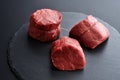 Three fresh raw Prime Black Angus beef steaks on stone background Royalty Free Stock Photo