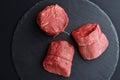 Three fresh raw Prime Black Angus beef steaks on stone background Royalty Free Stock Photo