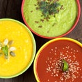 Three fresh soups on a wooden table Royalty Free Stock Photo