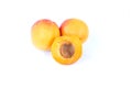 Three fresh sweet apricot fruit, whole and half, group of juicy ripe apricots closeup, isolated on the white background Royalty Free Stock Photo