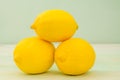 Three fresh yellow lemons on background