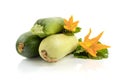 Three fresh zucchini with green leaves and flower isolated on a white background Royalty Free Stock Photo