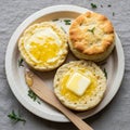 Three freshly baked biscuits are displayed on a light wooden plate. One biscuit is Royalty Free Stock Photo