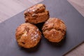 Three freshly baked fruit scones on slate plate . Royalty Free Stock Photo